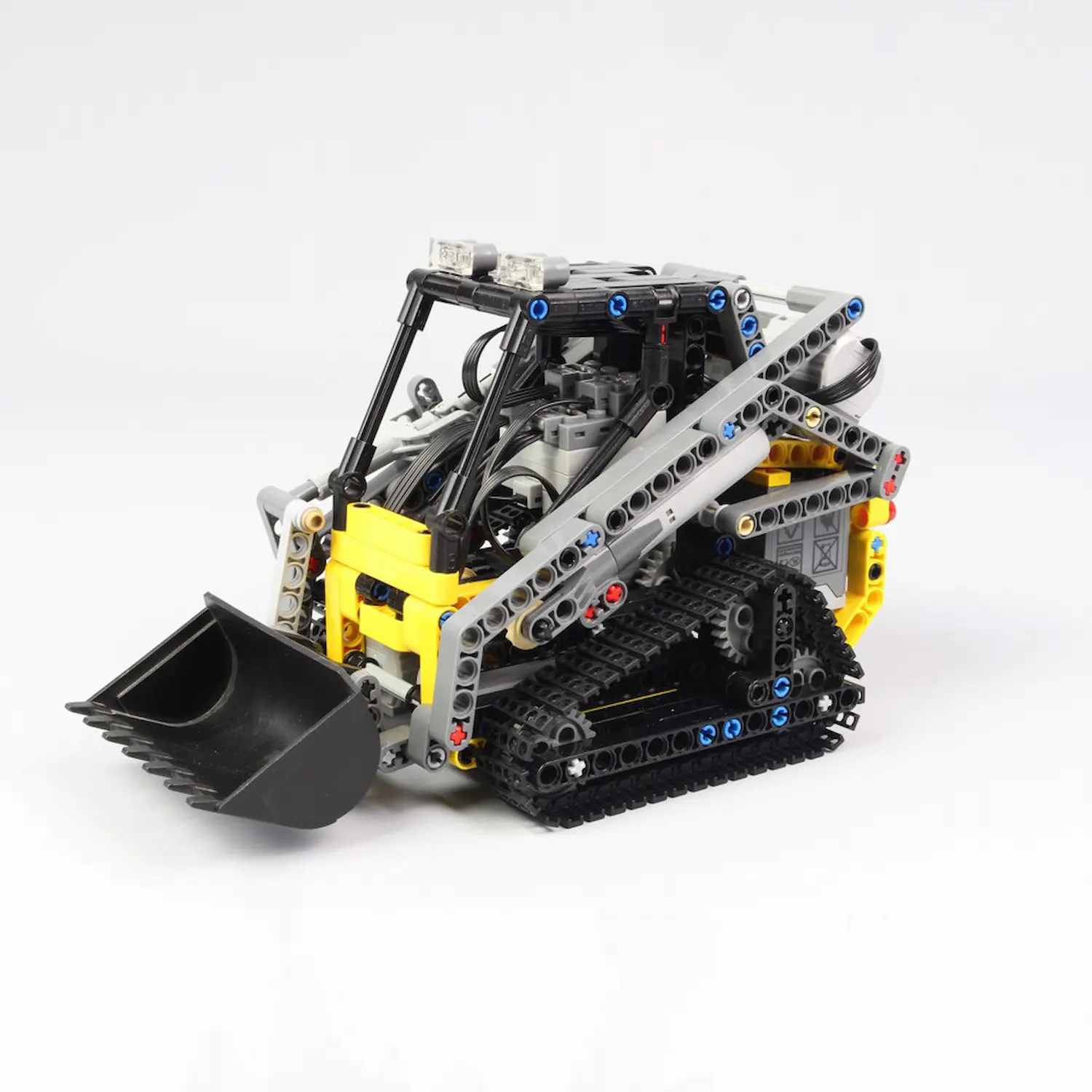 MOC 13349 - RC Technic Compact Tracked Loader(LEGO Alternative Bricks) in grey background MOC 13349 - RC Technic Compact Tracked Loader(LEGO Alternative Bricks) in grey background
