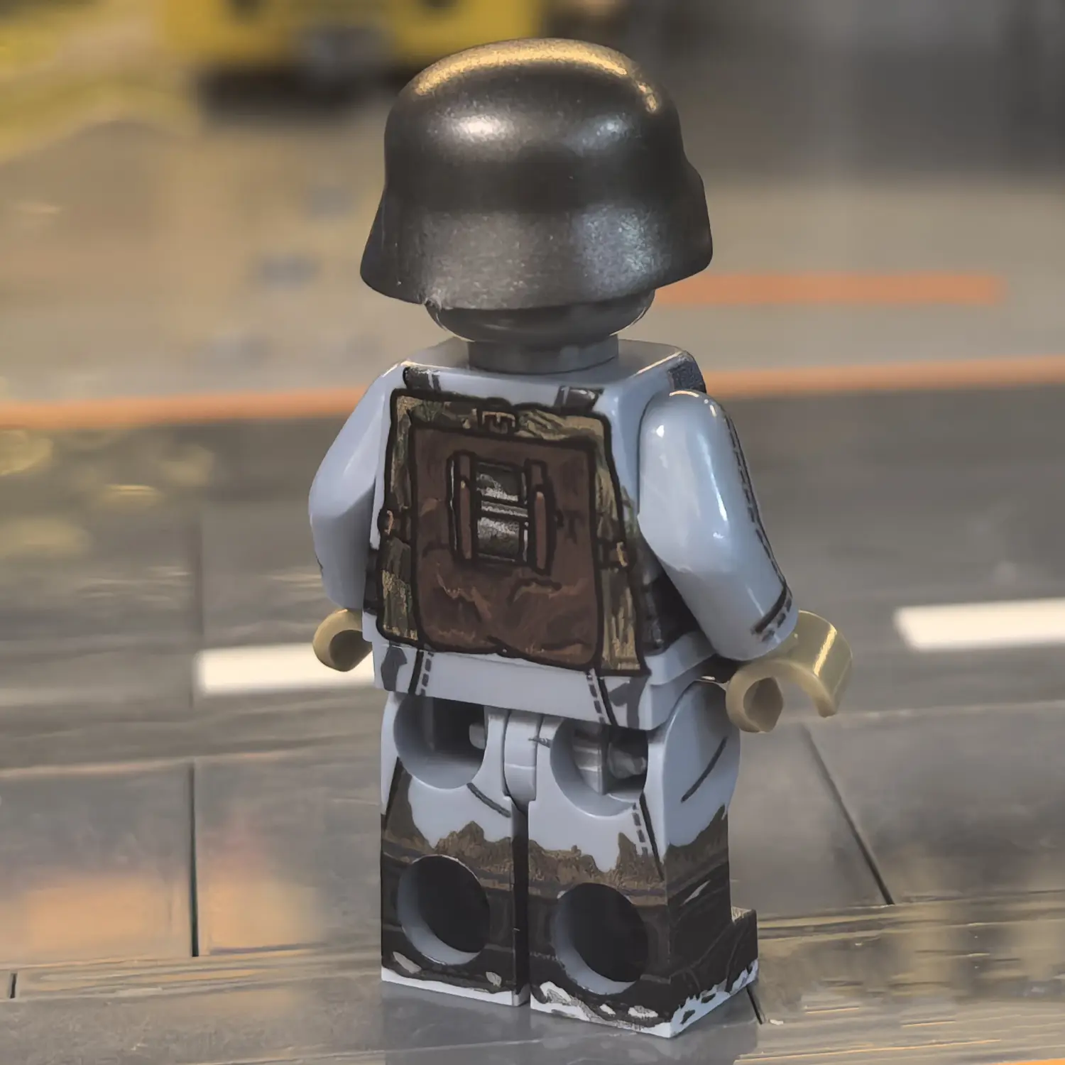 the left back side of the Minifigure - German Anti-Aircraft Artillery Soldier (Winter) WWII (LEGO Compatible)